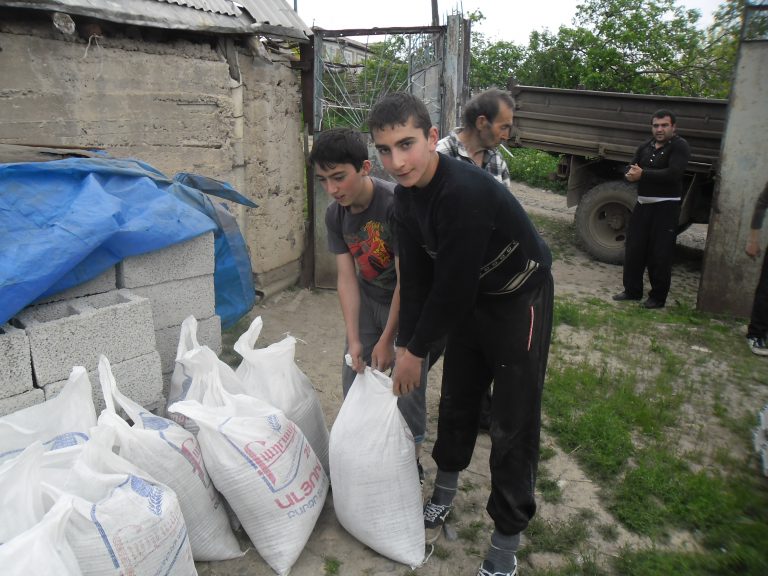 Janna's family helping unload the supplies for repairs.