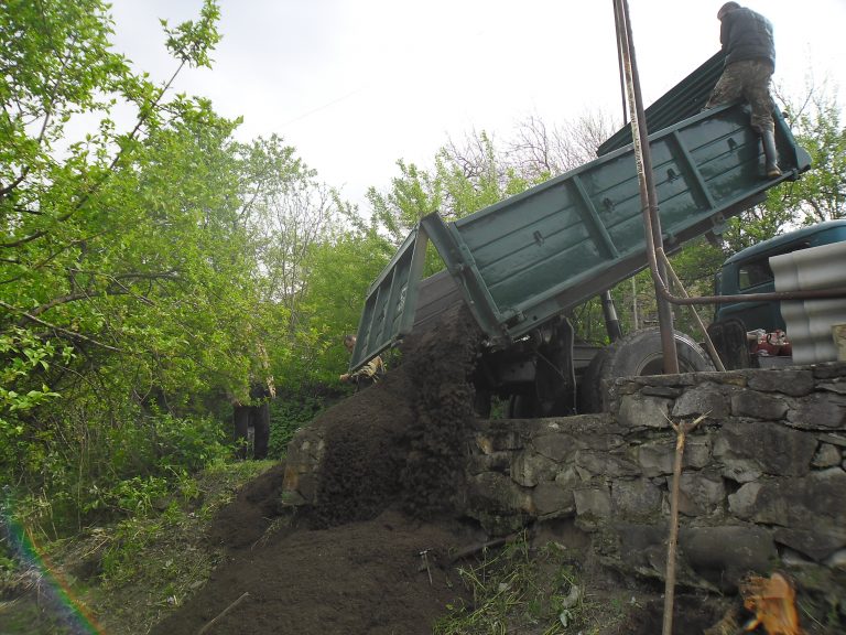 Sand being delivered to cement the floor of the barn.