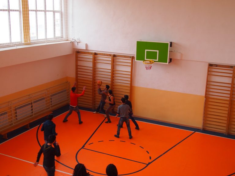 Students playing basketball in the newly renovated gym.