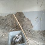 All the loose plaster being removed from the walls in the hallway at the school in Zorakan.