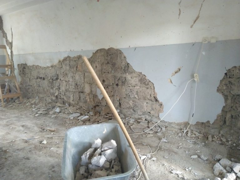 All the loose plaster being removed from the walls in the hallway at the school in Zorakan.