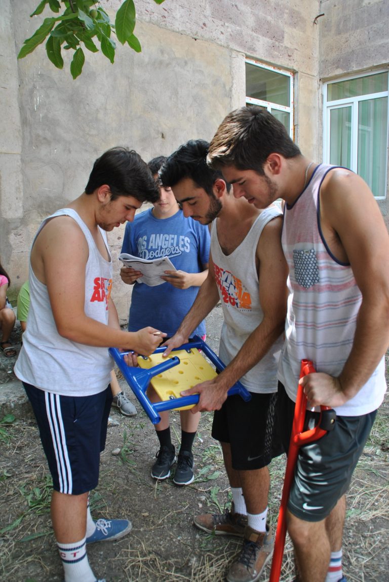 SERVICE Armenia participants worked carefully to assembly three play structures at Getashen.