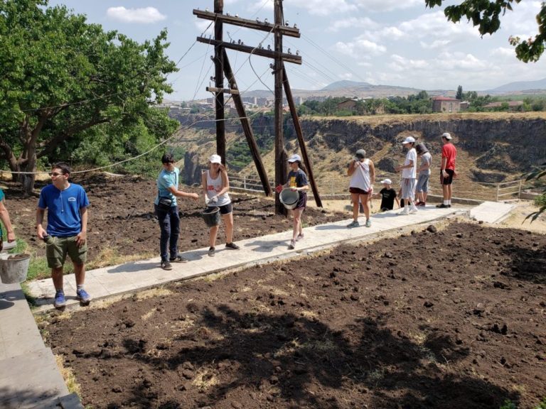 SERVICE Armenia 2019 participants and local kids spreading the top soil.