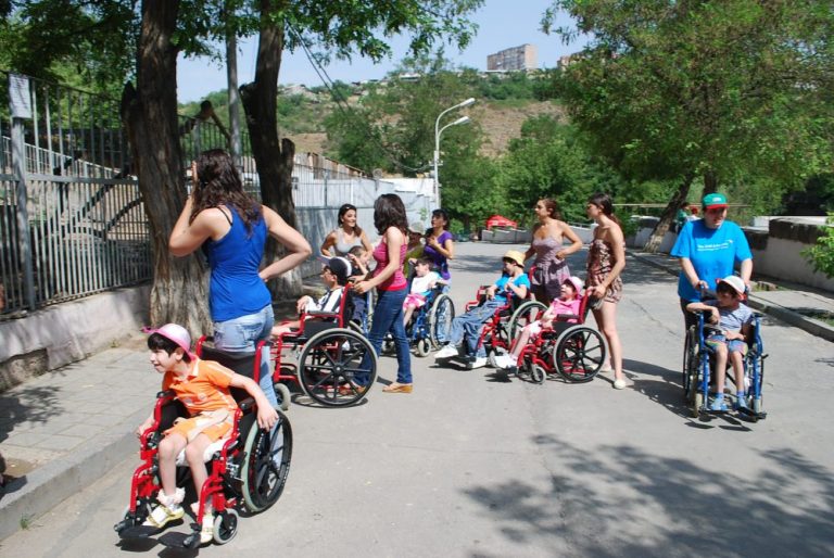 Volunteers help move the group throughout the Yerevan Zoo.