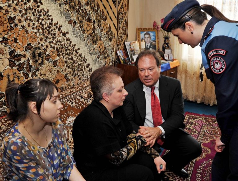 Chairman, Roger Strauch, consoling the mother and pregnant widow of Hrach Galstyan, in Gyumri.