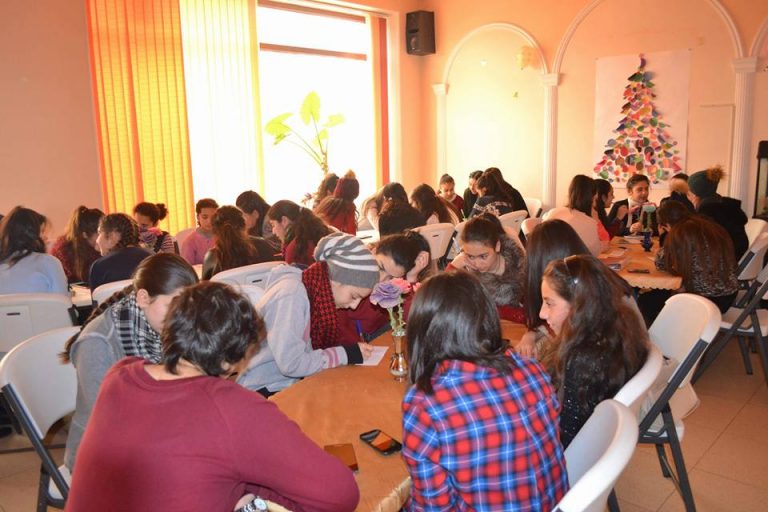 Nor Luyce mentees work on self assessments at their weekly meeting at the Debi Arach Children's Center.