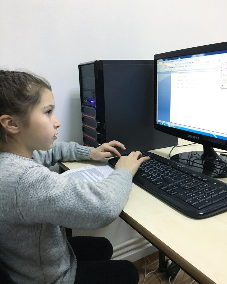 Children at Debi Arach attend a computer class where they learn several skills including typing.