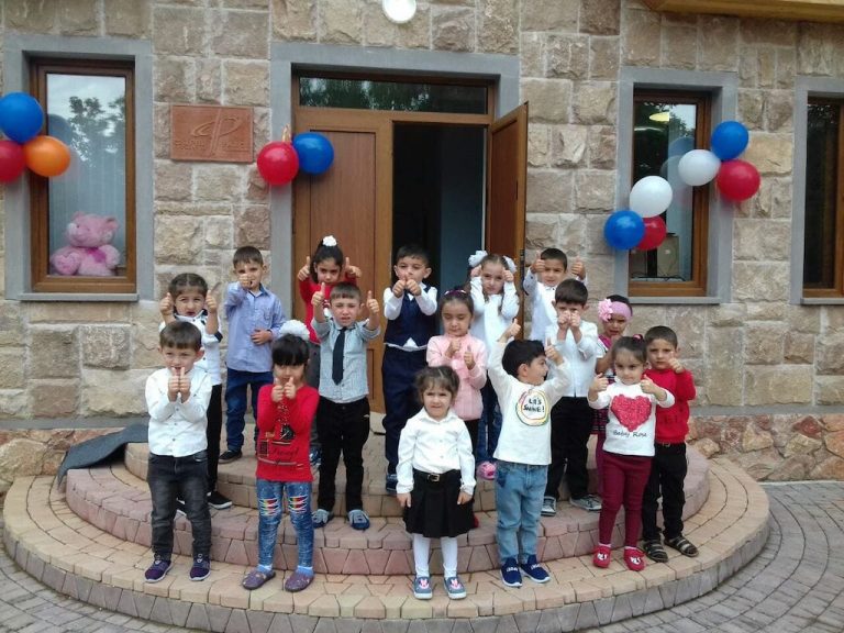 Children on the first day of school at the village of Baghanis in front of their brand new kindergarten