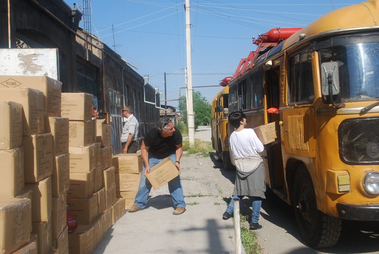 Loading the buses with shoes before heading to start distributions.