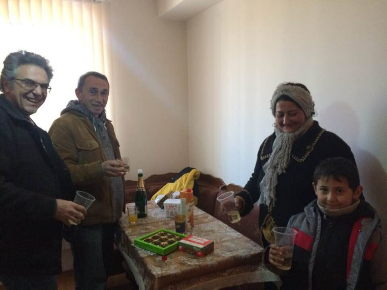 Sevan Amirians, Paros Foundation Project Manager, and Vahan Tumasyan, Shirak Center President, welcome Anna and Armen into their new home.
