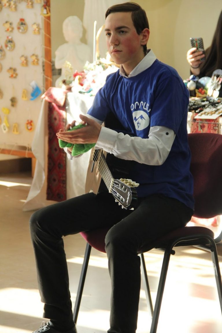 A student during his guitar lesson at the Vanadzor Orran Center.