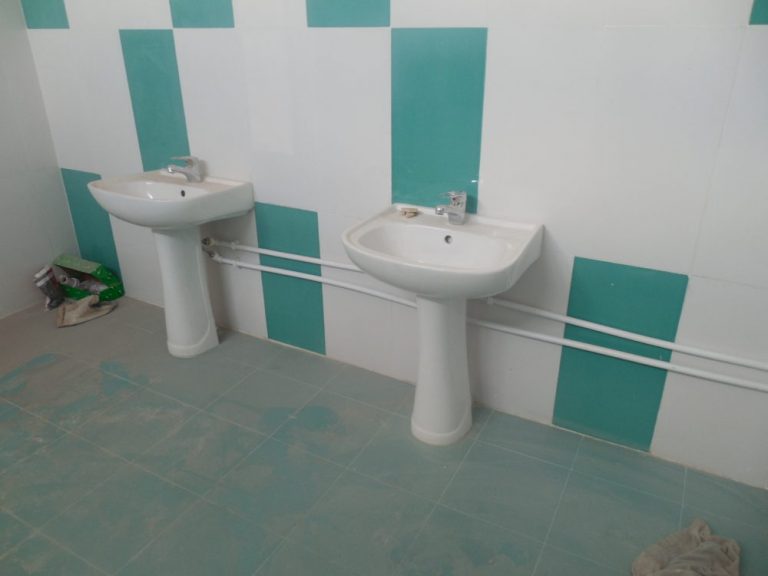 New bathroom fixtures and tiles at the kindergarten in Paravakar.