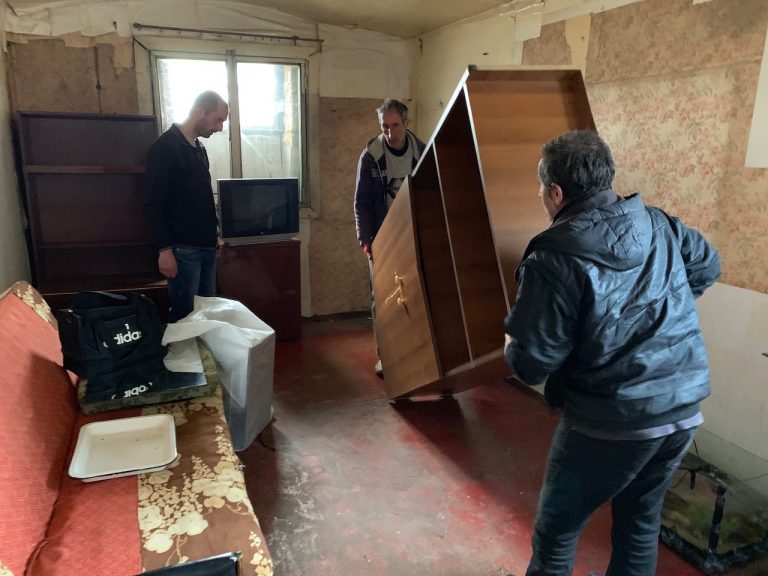 A crew from the Shirak Center NGO helps move the Sargsyan Family into their new home.