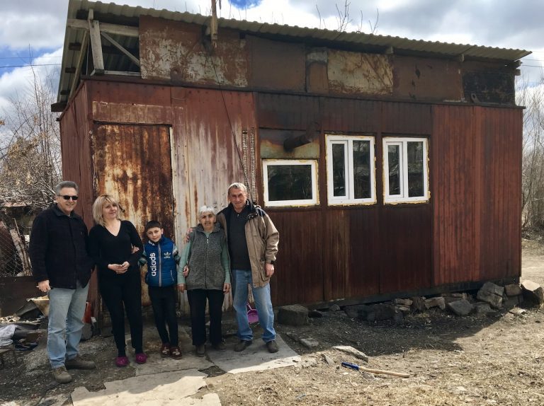 The Galoyan Family, along with Sevan Amirians from The Paros Foundation and Vahan Tumasyan from The Shirak Center NGO in front of the Galoyan's domik 
prior to their move.