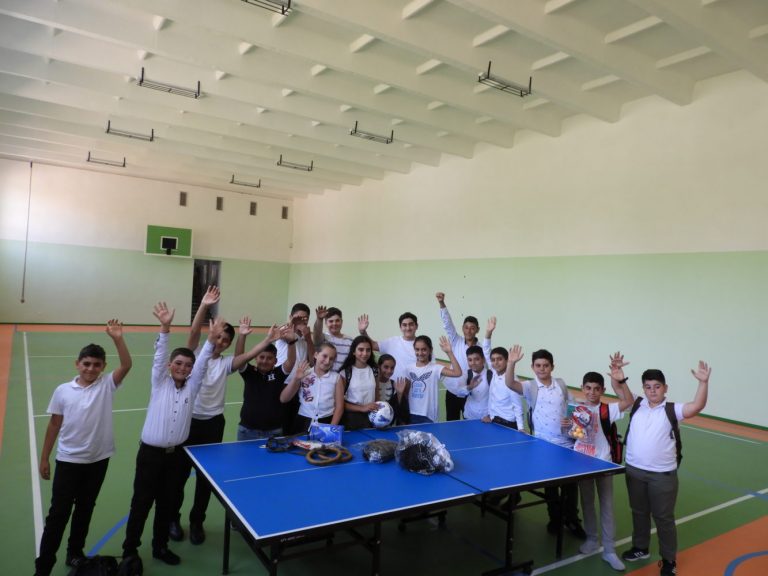 The happy faces of children in their newly renovated gym.