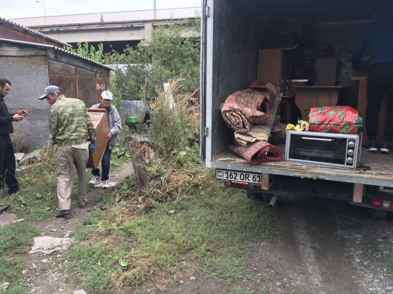 Our friends from the Shirak Center NGO help move the family into their new 
home.