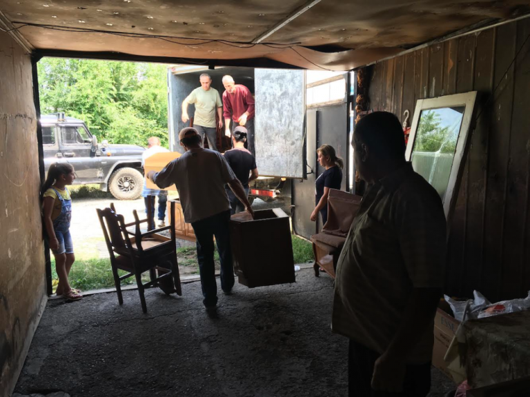 Friends, Paros & Shirak NGO staff help the Chakhalyan's pack their belongings.