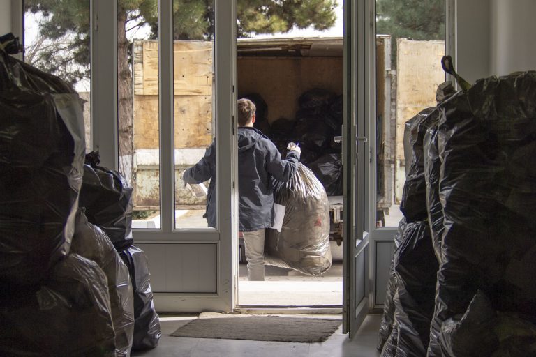 Paros Staffer, Peter Barsamian, helps load recyclables into the truck bound for Yerevan.