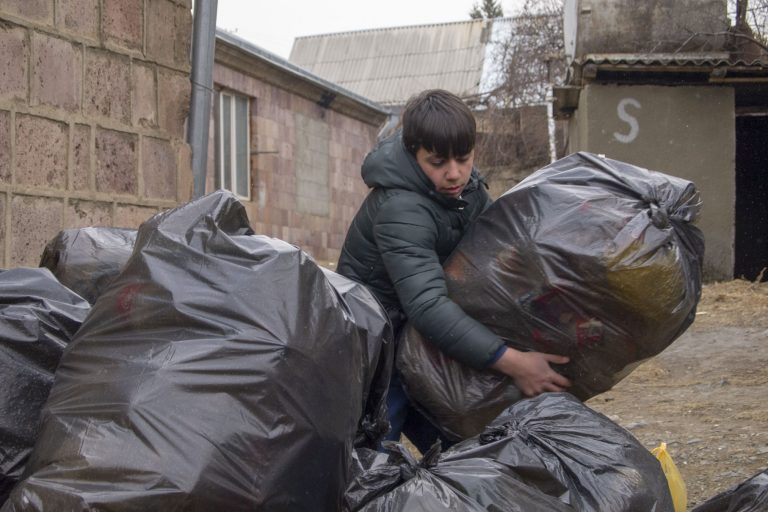 Students help load recycling materials onto the truck bound for Yerevan's recycling center.