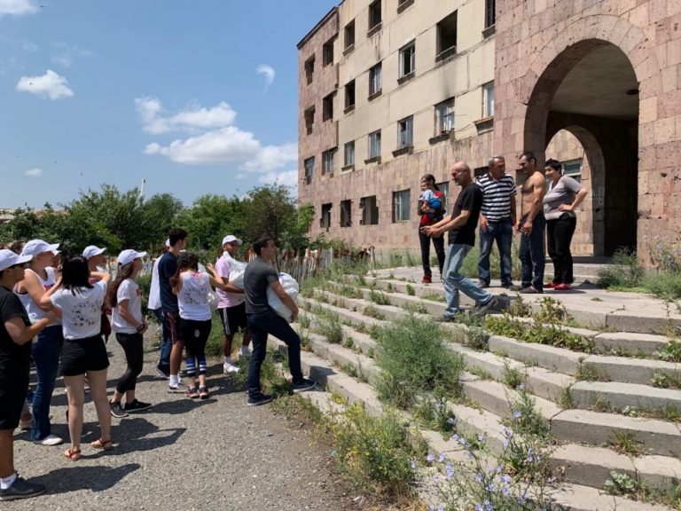 SERVICE Armenia participants delivering groceries to families living in this condemned building.