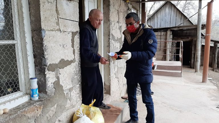 An elderly resident in the village of Norashen receives his food pack.