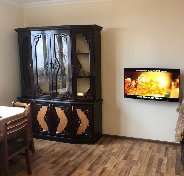 A new china hutch and television in Suren's home.