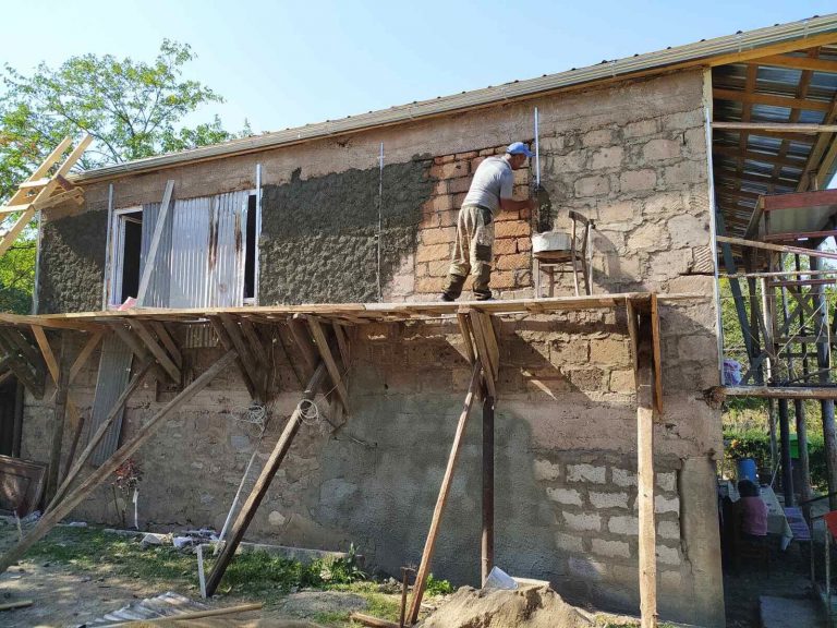 Emma's large village home is receiving new stucco.
