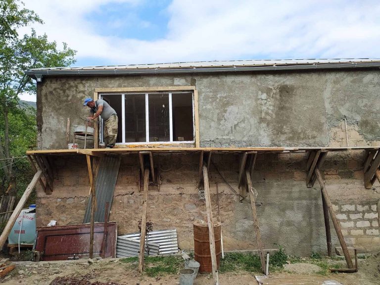 New stucco being installed on the exterior of Emma's home.