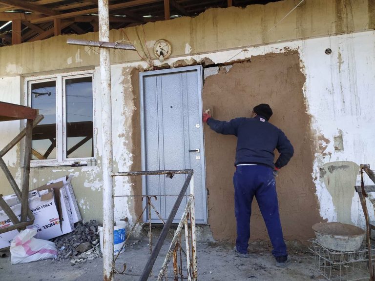 A new front door and windows installed at Emma's home.  The crew is working to complete all the exterior work prior to the onset of winter.