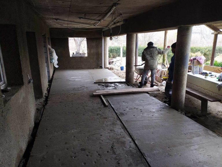 The crew is pouring concrete on the first floor summer living space.