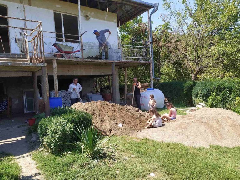 Sand and Cement are mixed together to create a solid subfloor throughout Emma's home.
