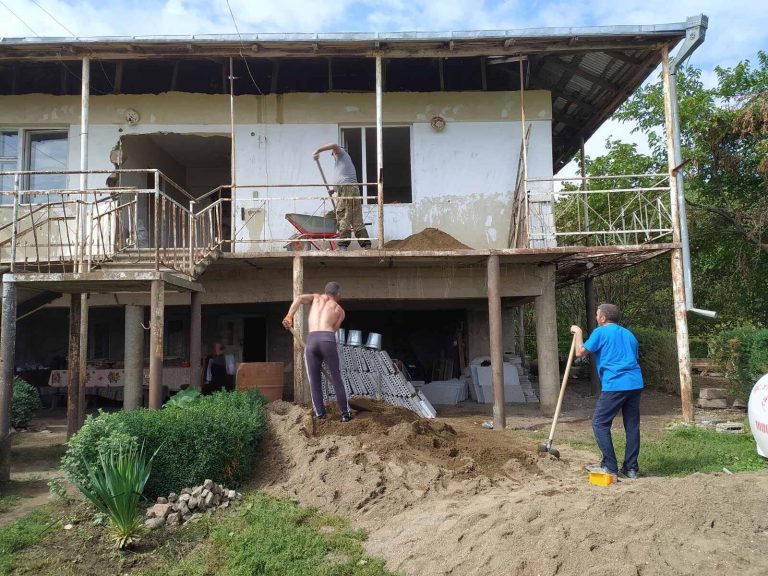 Crew members preparing concrete for the subfloors in Emma's home.