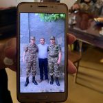 Displaced families showed Paros Team members photos of their family members they left behind to fight in Artsakh.
