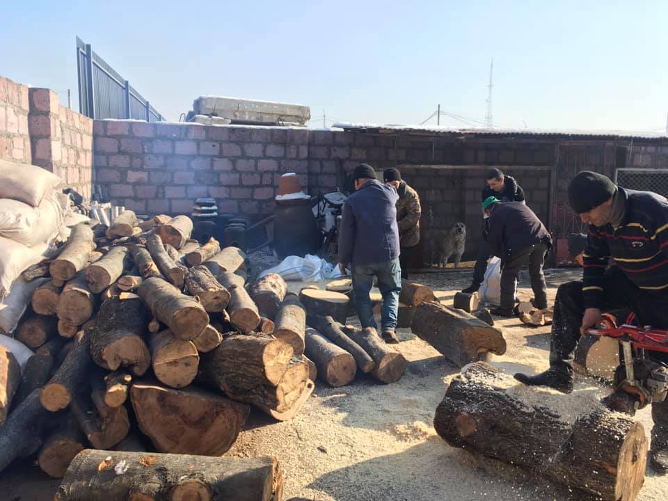 Shirak Center NGO staff preparing firewood for disbursement.