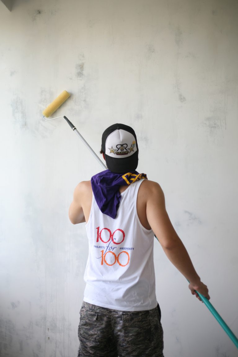 SERVICE Armenia 2013 participant primes the wall in preparation for paint.