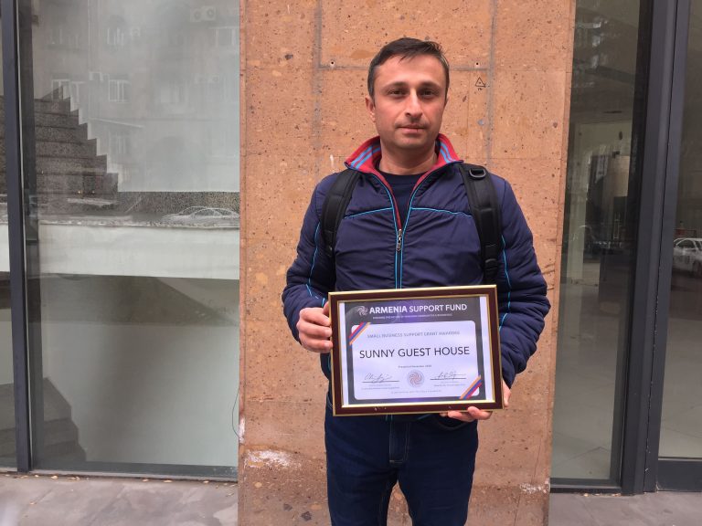 Gagik Axbalian accepting the grant for Sunny Guest House.