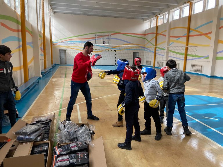 Students at the Medz Masrik school trying out their new boxing gear with their coach.