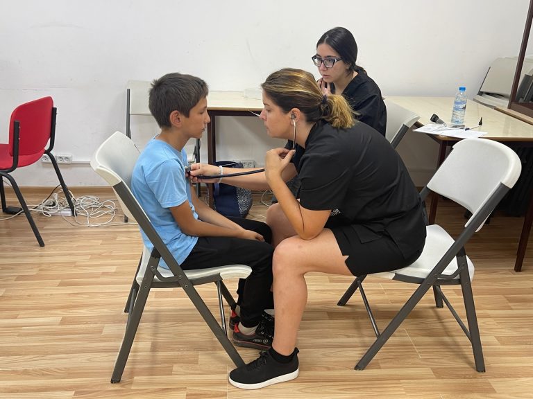Dr. Sylvia Kotikyan and medical student Julia Seropian conduct wellness screens for children at the Debi Arach Children's Center.