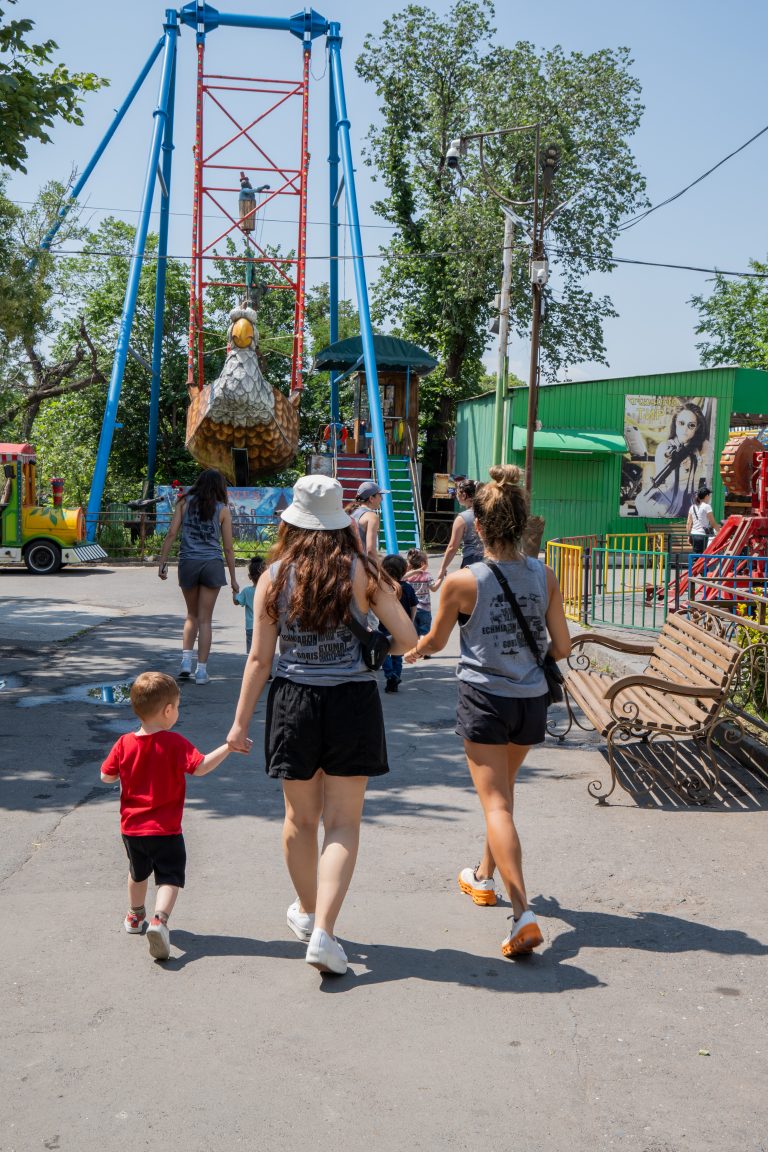 SERVICE participants taking the kids to the next ride.