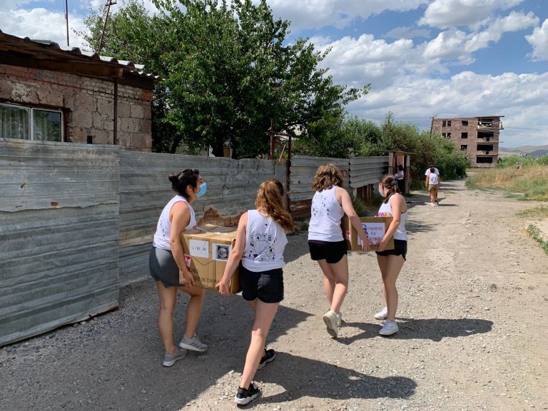 SERVICE Armenia participants on their way to the domiks to hand the families their groceries.