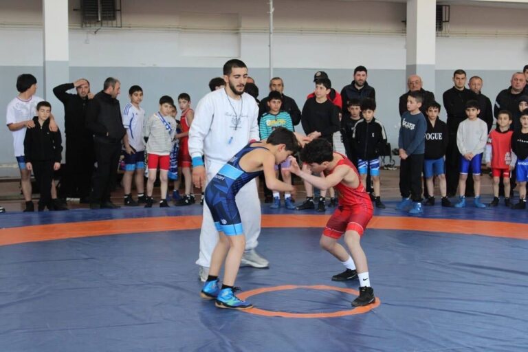 Young wrestlers compete during tournament.